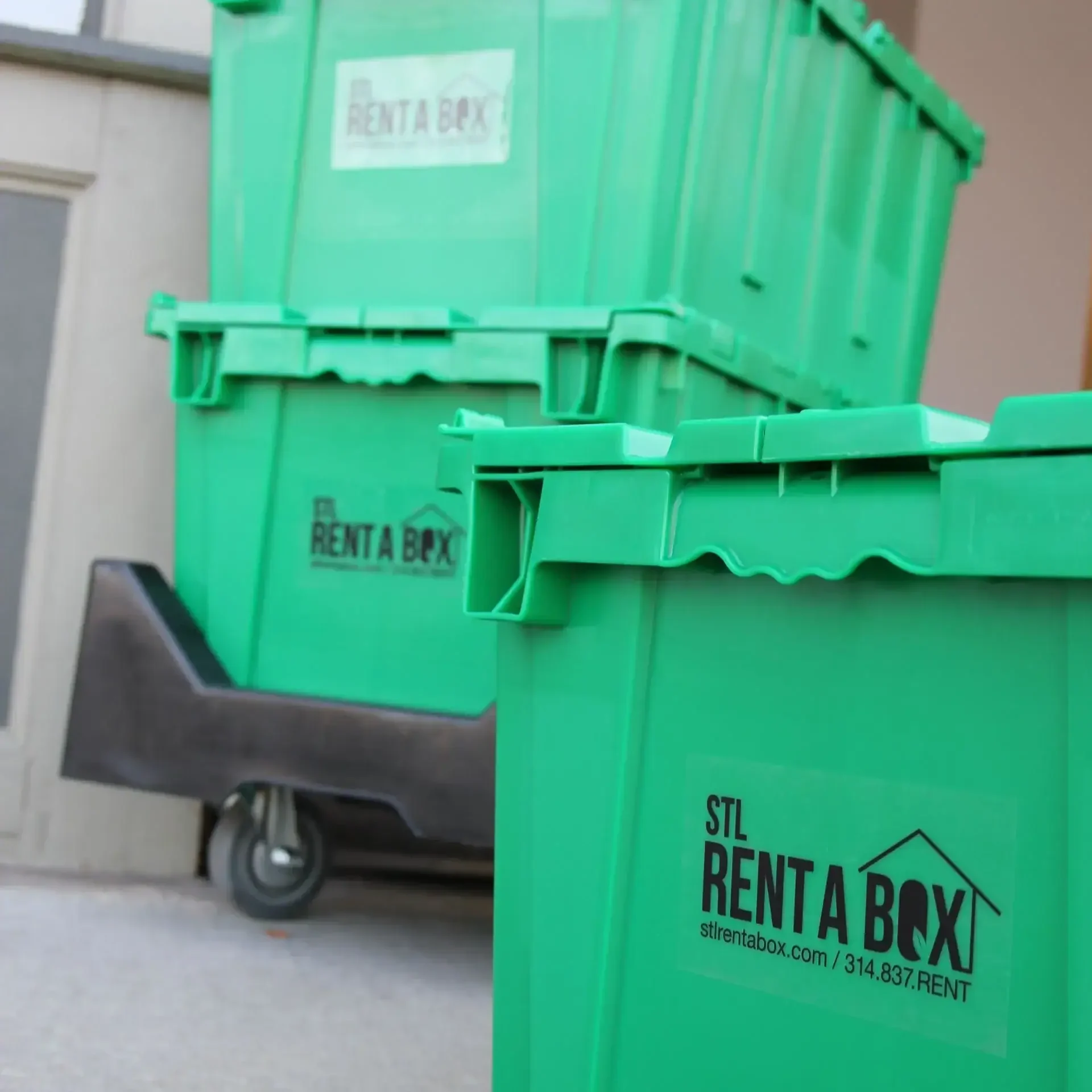 closeup rentabox containers on dolly near doorway closeup rentabox containers on dolly near doorway