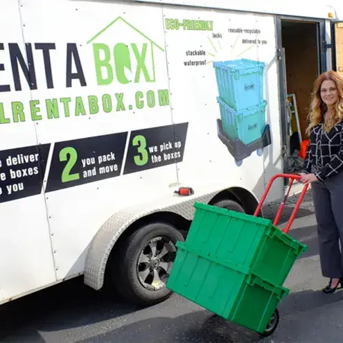 moving day stl rentabox trailer scene Woman with eco-friendly moving boxes and trailer.