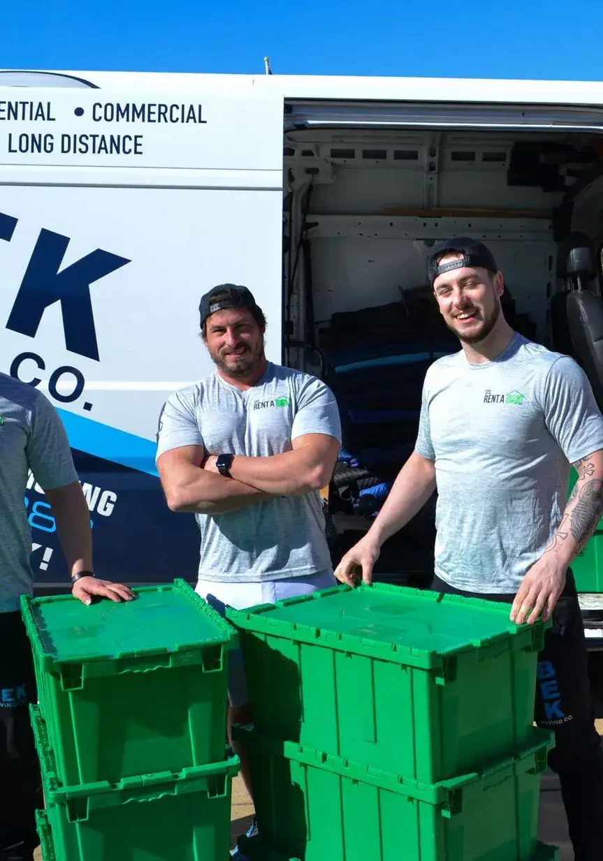 moving team bek van green boxes Three movers with moving van and green boxes.