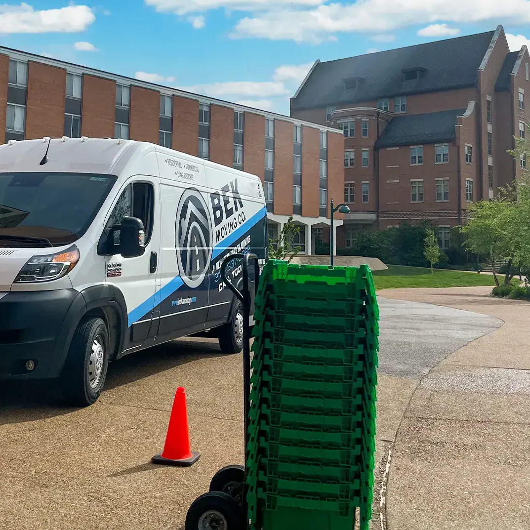 stack of green moving boxes bek moving van campus background stack of green moving boxes bek moving van campus background