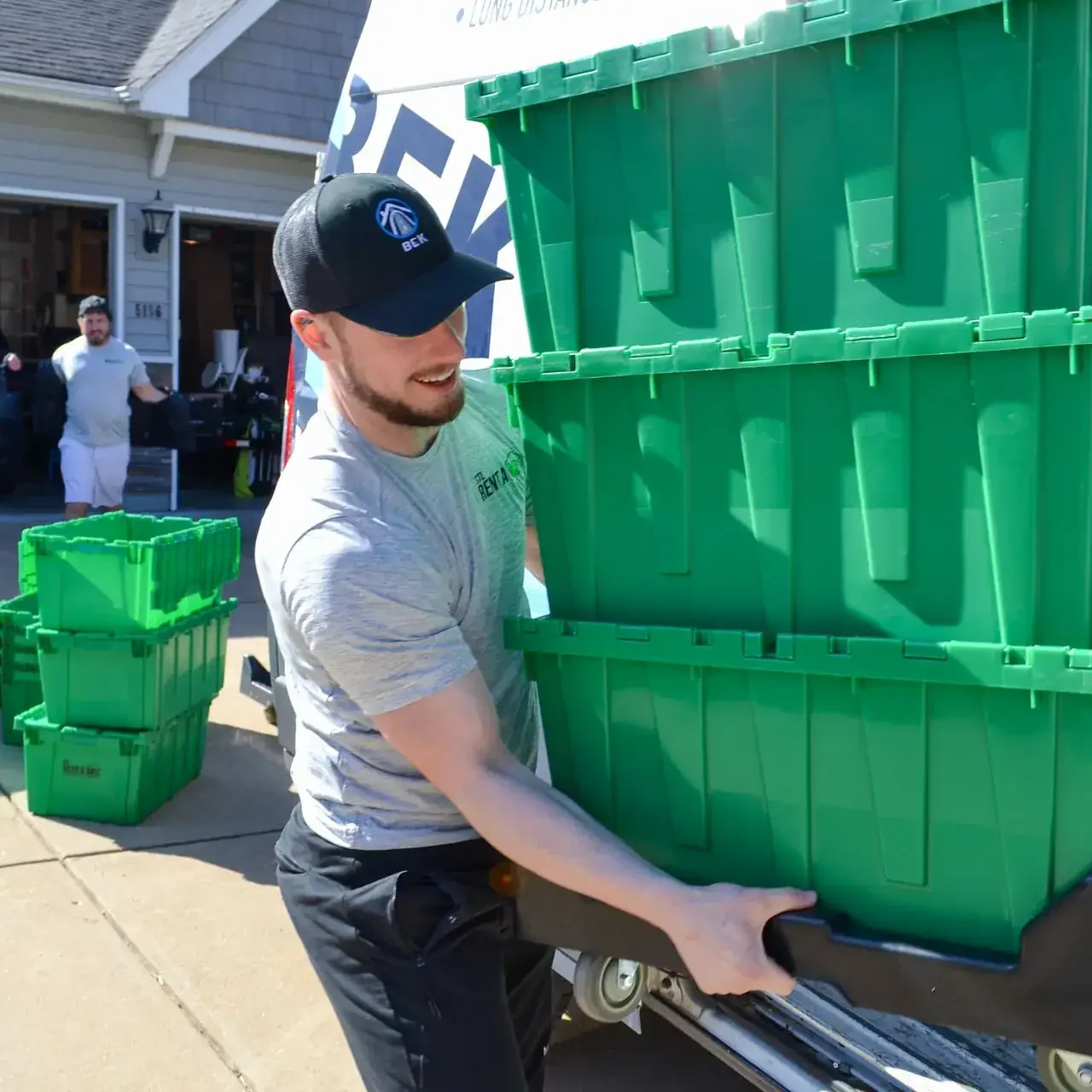 worker loading rent a box crates onto ramp worker loading rent a box crates onto ramp